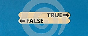 True or false symbol. Concept word True or False on beautiful wooden stick. Beautiful blue table blue background. Business and