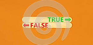 True or false symbol. Concept word True or False on beautiful wooden stick. Beautiful orange table orange background. Business and