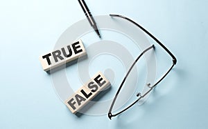 TRUE FALSE text on the wooden block ,blue background