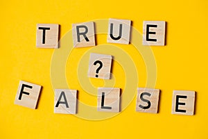 True or false words on a yellow background with a question mark. Choice concept