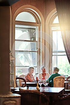 True friendship is timeless. Cropped shot of a group of senior female friends enjoying a lunch date.