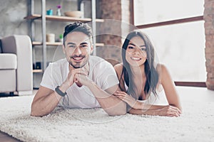 True love. Happy beautiful married latino mulatto couple is chilling out lying on the carpet at the floor at home