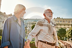 True love never gets old. Portrait of beautiful and happy stylish senior couple smiling and walking together outdoors