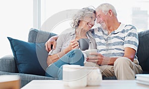 True love never retires. a senior couple enjoying a relaxing coffee break on the sofa at home.