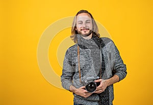 A true shutterbug. Photographer yellow background. Photographer hold photo camera.