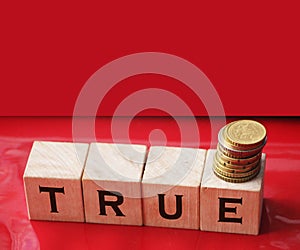 True word on wooden cubes on red. True or false facts, real and fake news concept