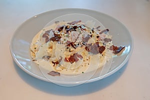 Truffle Alfredo Sauce delicately drizzled on a white plate