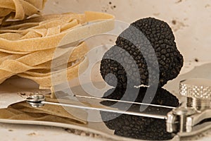 Truffle on Steel Slicer Alongside Pasta