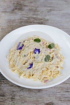 Truffled Mushroom, Bacon, Egg Fettucine pasta noodles served in a dish isolated on grey background side view