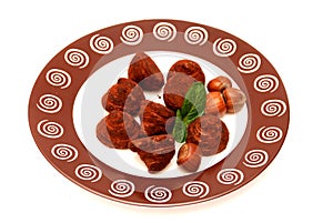 Truffles, hazelnuts and mint leaves on a plate