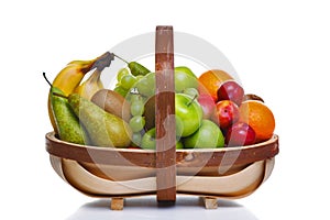 Trug full of fresh fruit isolated on white