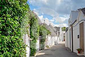 Trulli of Alberobello, Puglia, Italy: Typical houses built with dry stone walls and conical roofs. In a beautiful sunny day.