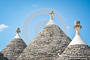 Trulli of Alberobello, Puglia, Italy: Typical houses built with dry stone walls and conical roofs. In a beautiful sunny day.