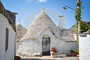 Trulli of Alberobello, Puglia, Italy: Typical houses built with dry stone walls and conical roofs. In a beautiful sunny day.