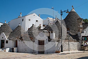 Trulli from Indipendenza street with Monte Santo street in Alberobello, Italy.