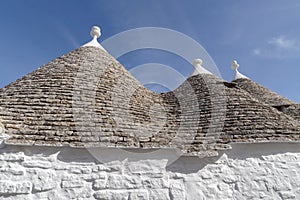 Trulli roofs against a blue sky. Alberobello, Apulia, Italy