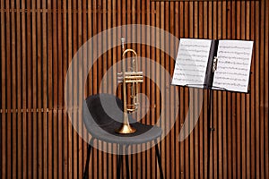 Trumpet, chair and note stand with music sheets