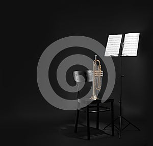 Trumpet, chair and note stand with music sheets on black. Space for text