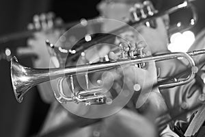 Trumpet in the hands of a musician in the band closeup