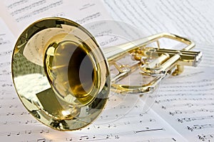 Trumpet lying on sheet music