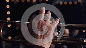 Trumpet player. Trumpeter hands playing brass music instrument close up. Close up of trumpet players fingers working the