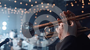 Trumpet player. Trumpeter hands playing brass music instrument close up. Close up of trumpet players fingers working the