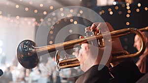 Trumpet player. Trumpeter hands playing brass music instrument close up. Close up of trumpet players fingers working the