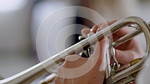 Trumpet player. Trumpeter hands playing brass music instrument close up. Detail of the player's fingers on trumpet