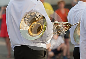 Trumpeter with French horn waits start of parade