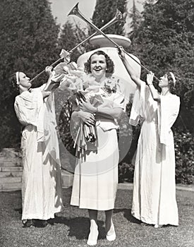 Trumpeters heralding woman carrying bouquet of flowers