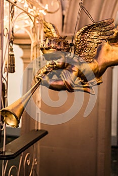 A trumpeting golden music angel statue detail on a german christmas market