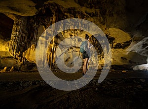 Trung Trung Cave Cat Ba Vietnam Girl Tourist admires beautiful Stalactite formations