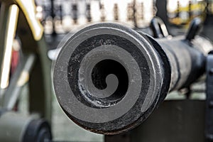 Trunk of a heavy cast-iron gun close up, smooth-bore cannon