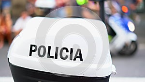 Trunk of police motorcycle with inscription `Policia` nd police flashing lights