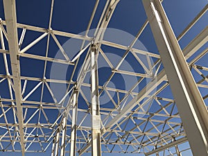 Truss ceiling and metal pillars and girders. Support constructions. Industrial building metal framework