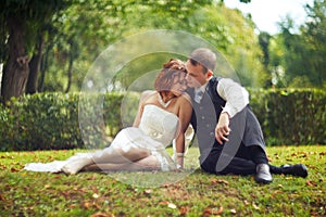 Trust and hug - wedding couple rests on the green ground