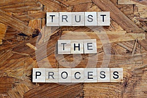 trust the process text on wooden square, motivation quotes.