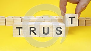 trust symbol. businessman turns wooden cubes the words renew. beautiful yellow background, copy space. business, concept