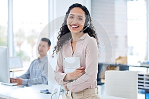 Trust us to sort out any problems you have. a young call centre agent sitting and holding a digital table while her