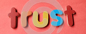 Trust word in business concept. Trust word written on red background.