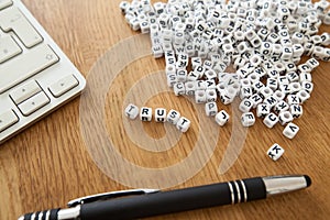 Trust word written on cube shape white blocks on wooden Business table