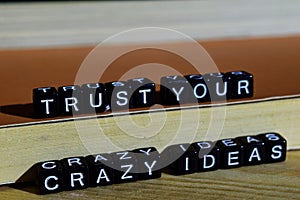 Trust your crazy ideas on wooden blocks. Motivation and inspiration concept