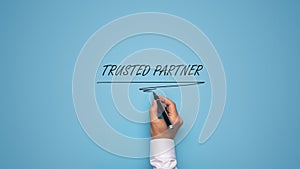 Trusted partner sign over blue background photo