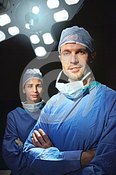Trusted team of healthcare professionals. Cropped portrait of two doctors against a dark background.