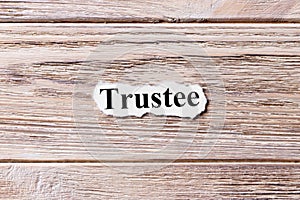 Trustee of the word on paper. concept. Words of Trustee on a wooden background photo
