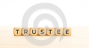 Trustee word on wooden block