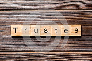 Trustee word written on wood block. trustee text on table, concept