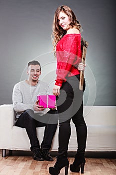 Trusting guy giving present to misleading girl