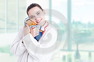 Trustworthy pediatrician hugging plush toy