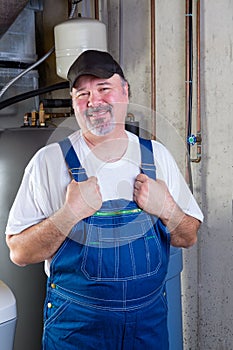 Trustworthy workman in a basement utility room photo